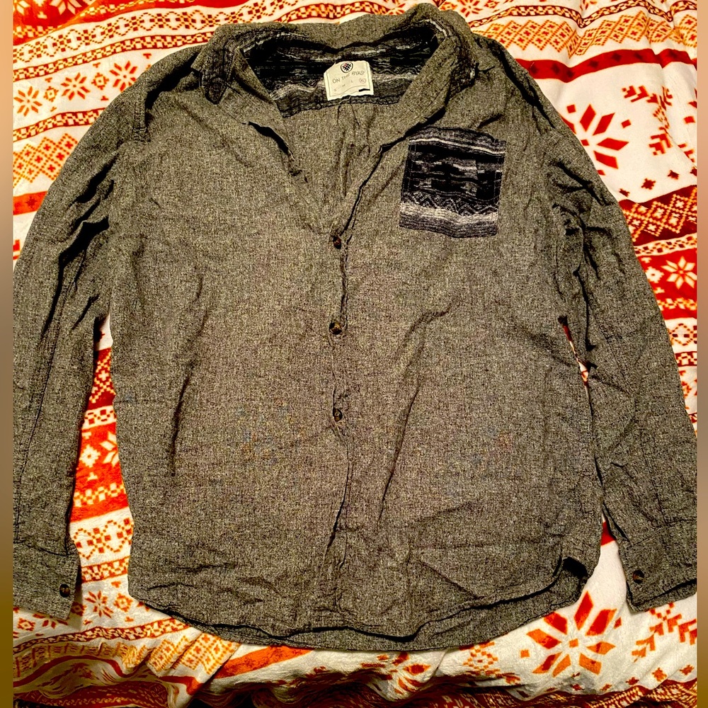 On the byas men’s button down shirt. Gray with design on pocket size X-Large.